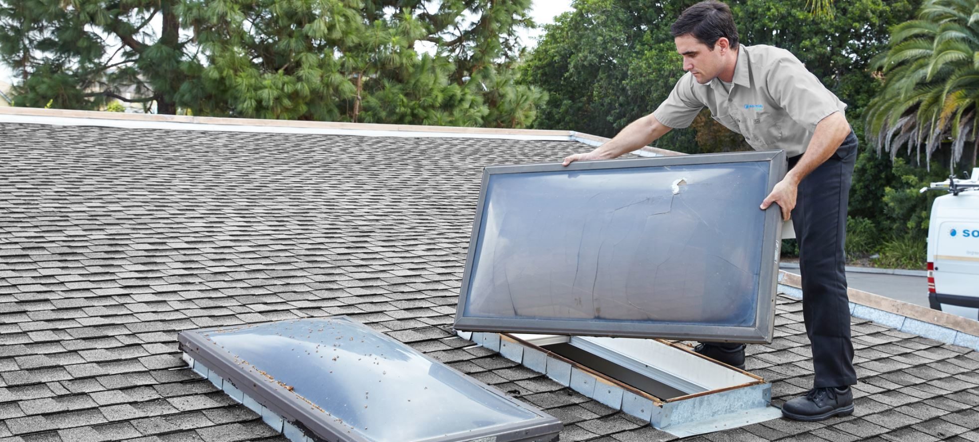 Installer removing old skylight.